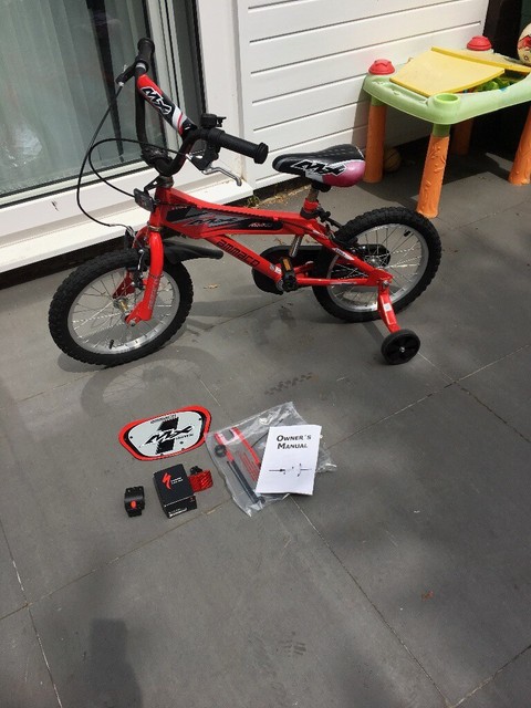 red bike with stabilisers